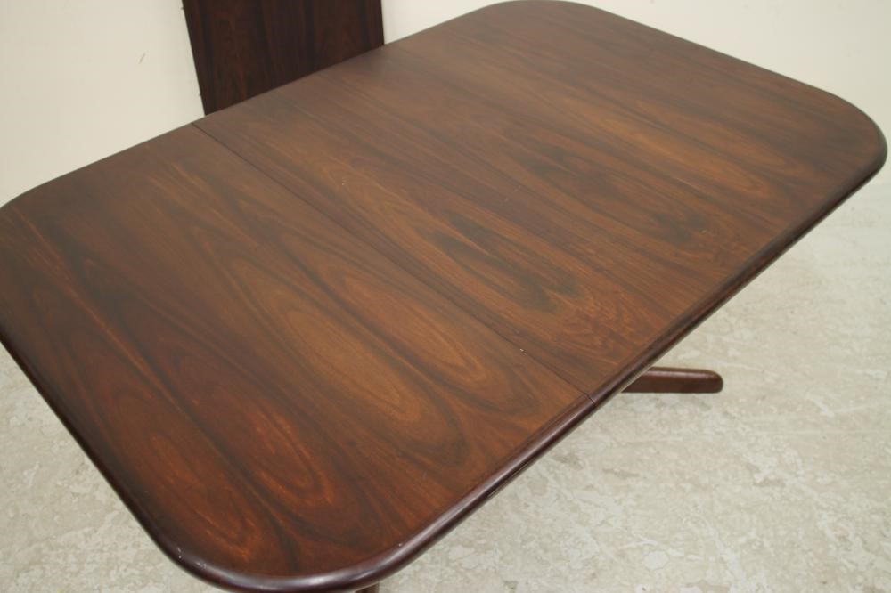 A DANISH ROSEWOOD EXTENDING DINING TABLE Image