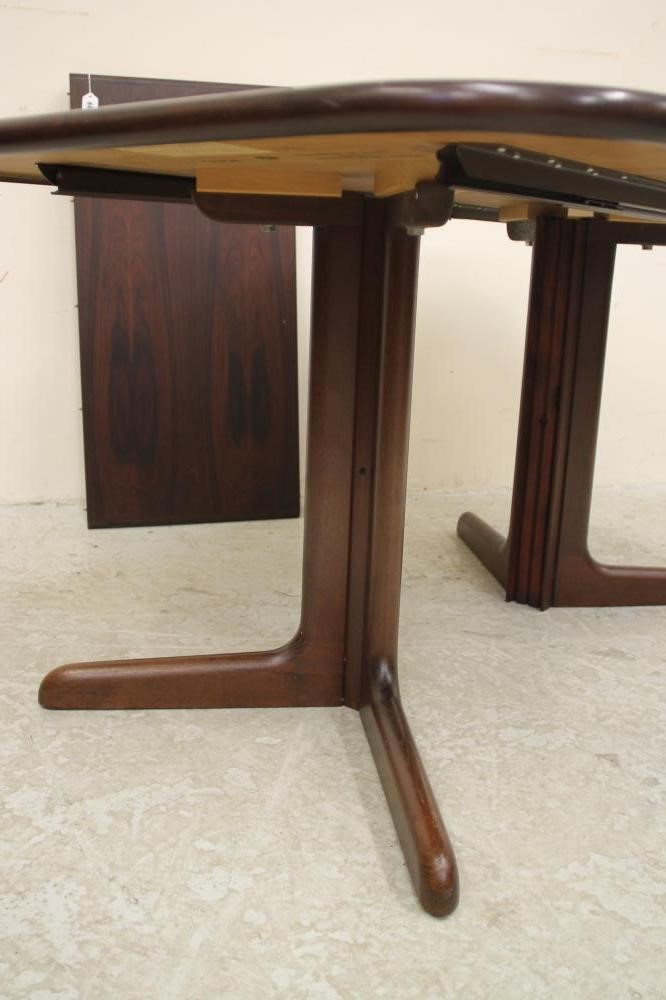 A DANISH ROSEWOOD EXTENDING DINING TABLE Image