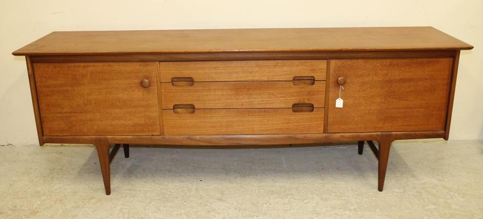 A TEAK SIDEBOARD by A. Younger Ltd. of low rounded oblong form Image