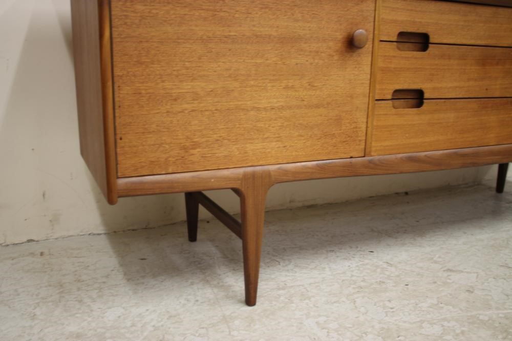 A TEAK SIDEBOARD by A. Younger Ltd. of low rounded oblong form Image