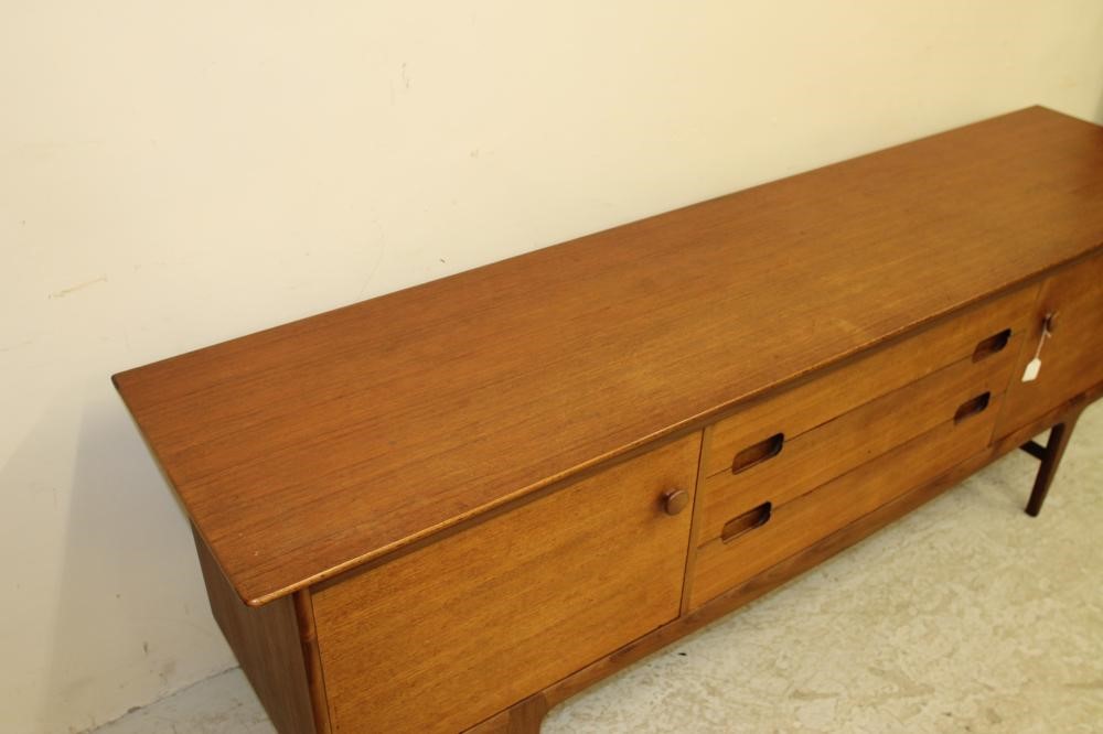 A TEAK SIDEBOARD by A. Younger Ltd. of low rounded oblong form Image