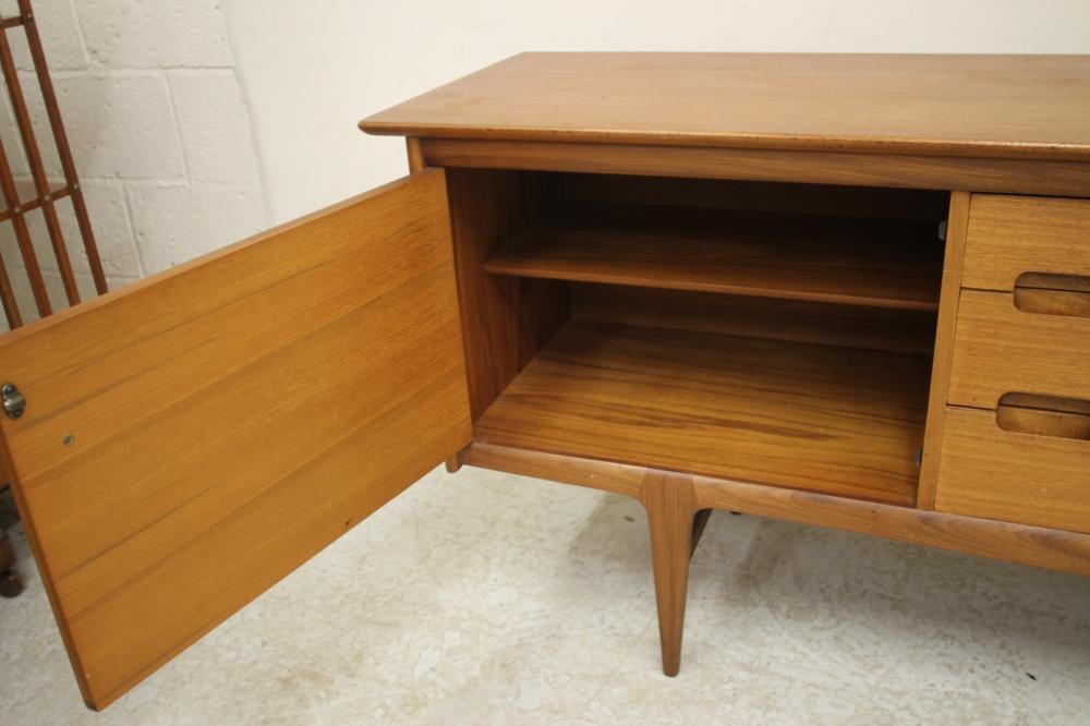 A TEAK SIDEBOARD by A. Younger Ltd. of low rounded oblong form Image