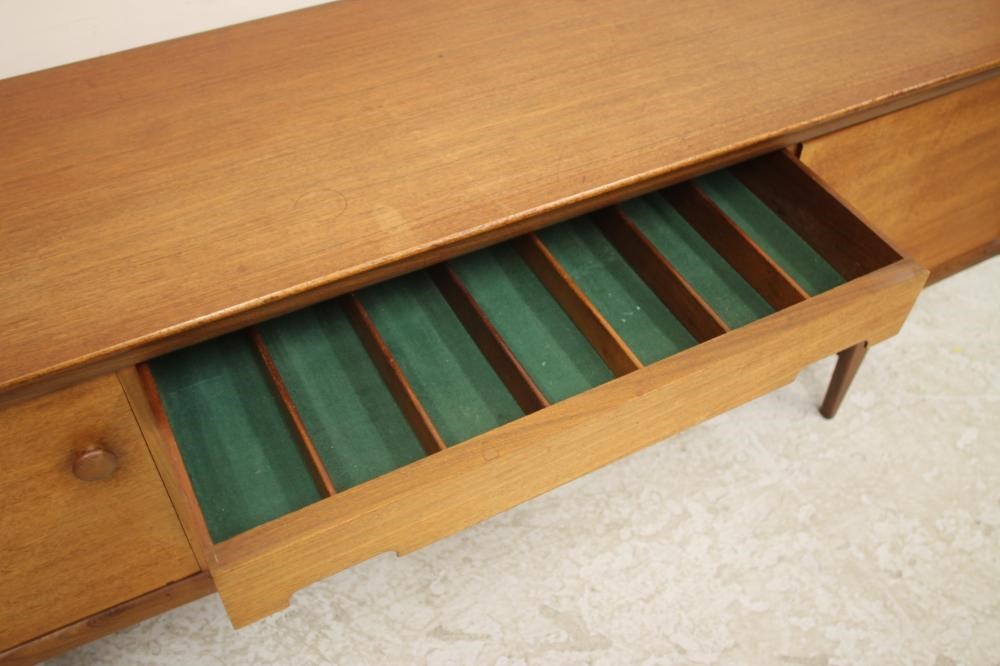 A TEAK SIDEBOARD by A. Younger Ltd. of low rounded oblong form Image