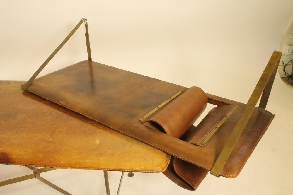 A LEATHER BOUND AND BRASS COFFEE TABLE in the manner of Jacques Adnet Image