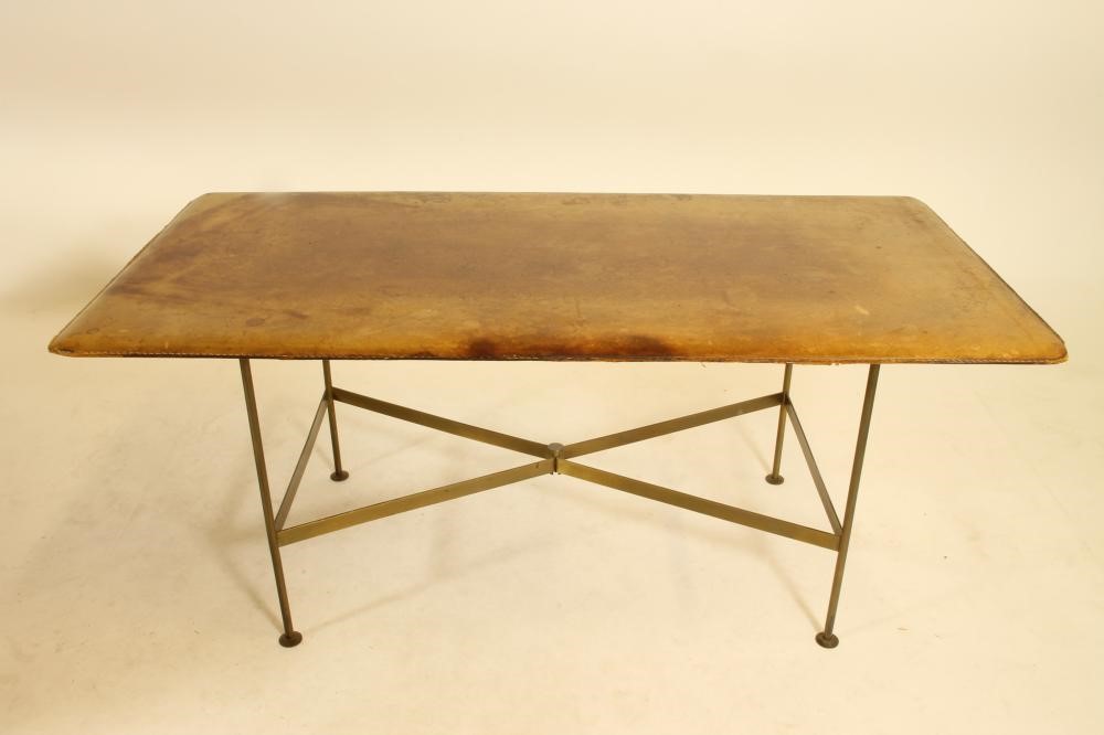 A LEATHER BOUND AND BRASS COFFEE TABLE in the manner of Jacques Adnet Image