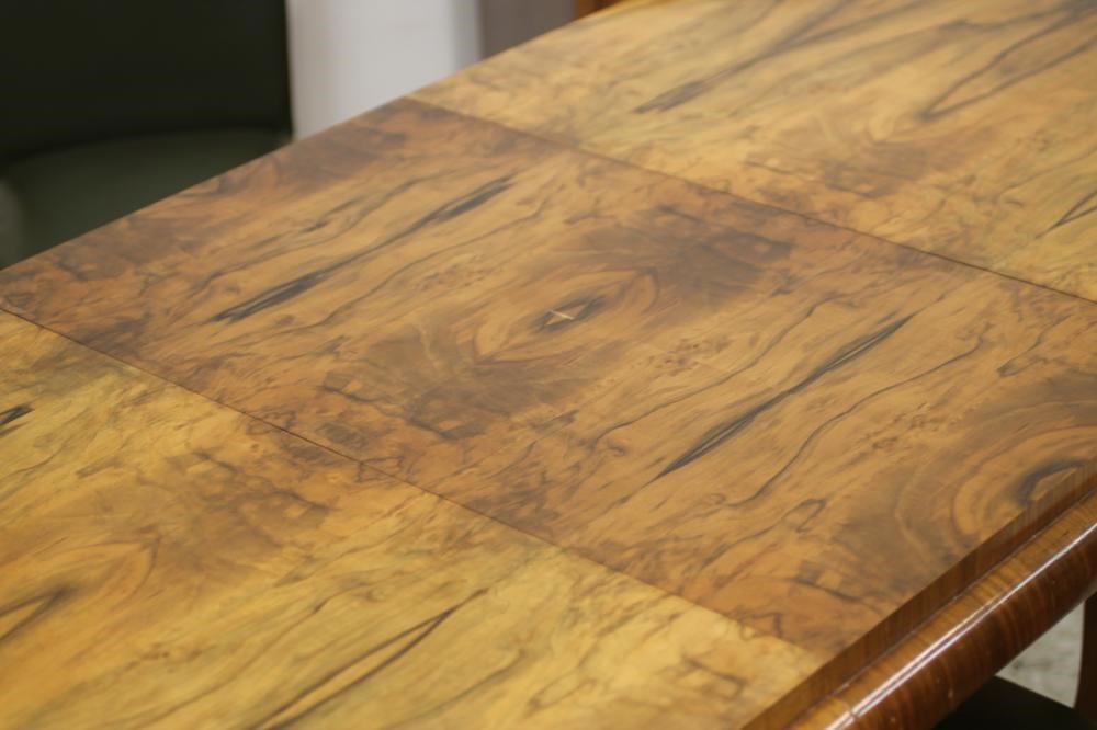 AN ART DECO BURR WALNUT DINING SUITE comprising extending dining table of rounded oblong form with Image