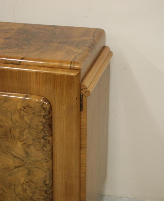 AN ART DECO BURR WALNUT DINING SUITE comprising extending dining table of rounded oblong form with Image