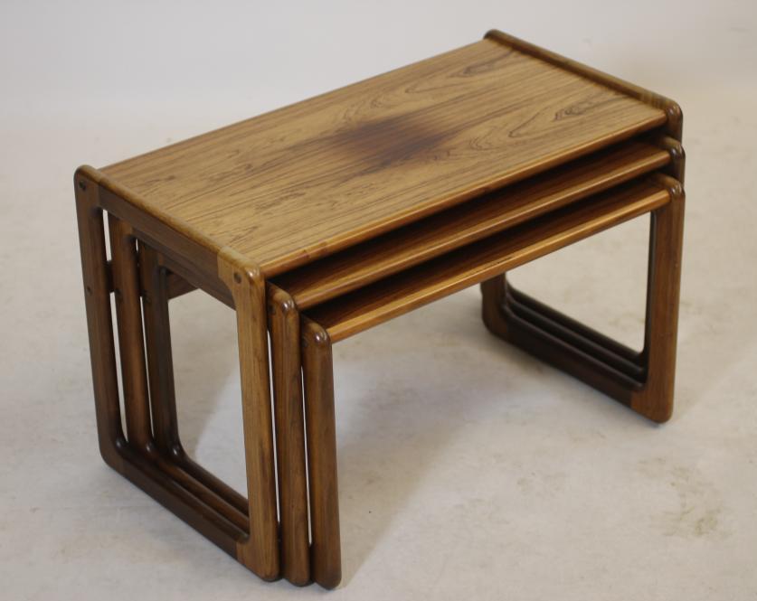 A NEST OF THREE ROSEWOOD TABLES Image