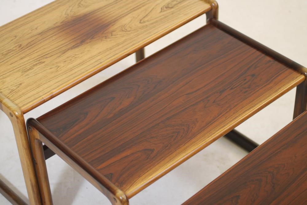 A NEST OF THREE ROSEWOOD TABLES Image