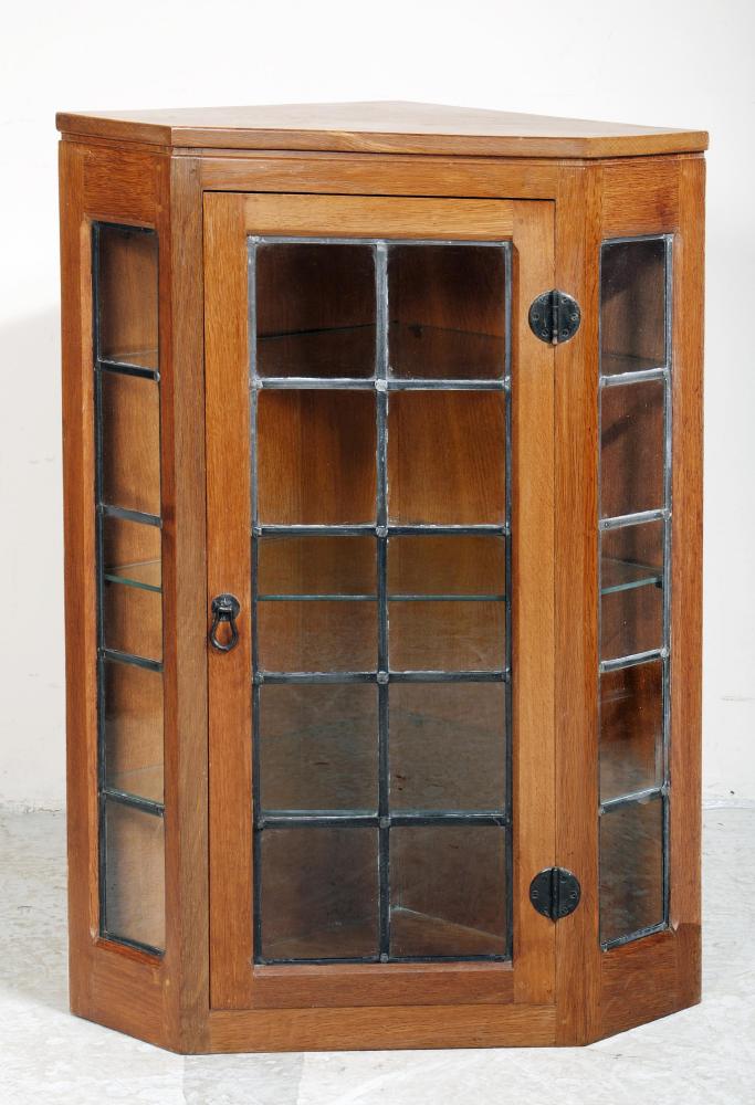 AN OAK AND LEAD GLAZED CORNER CUPBOARD BY ROBERT THOMPSON Image