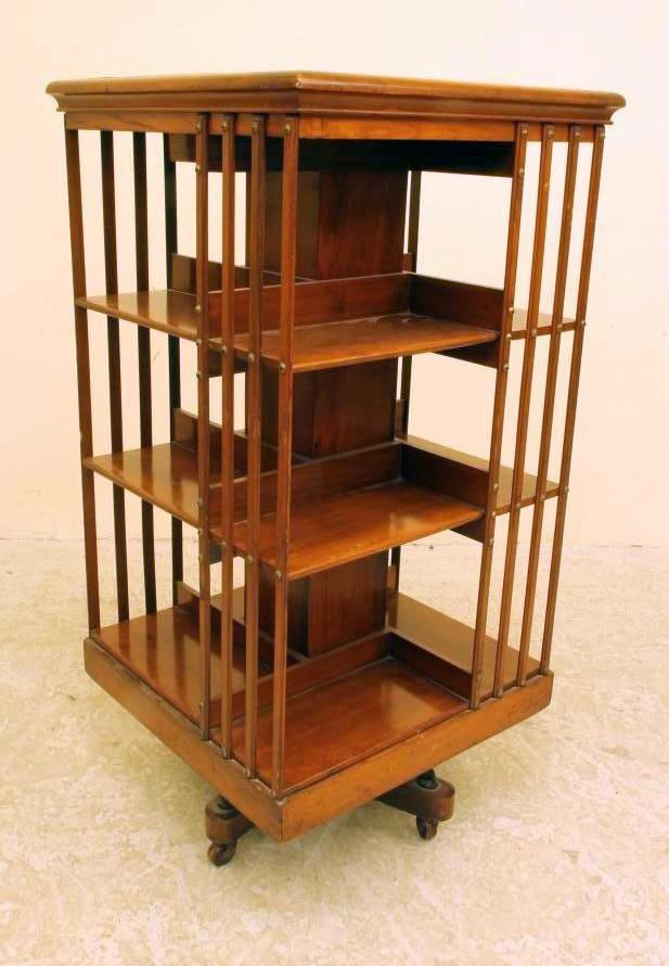 A LATE VICTORIAN MAHOGANY REVOLVING BOOKCASE of three tier square form with part slatted sides Image