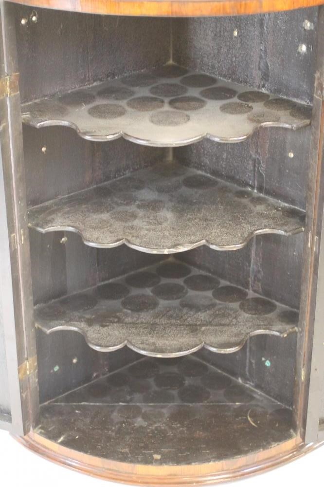 A GEORGIAN MAHOGANY AND ROSEWOOD BANDED CORNER CUPBOARD Image