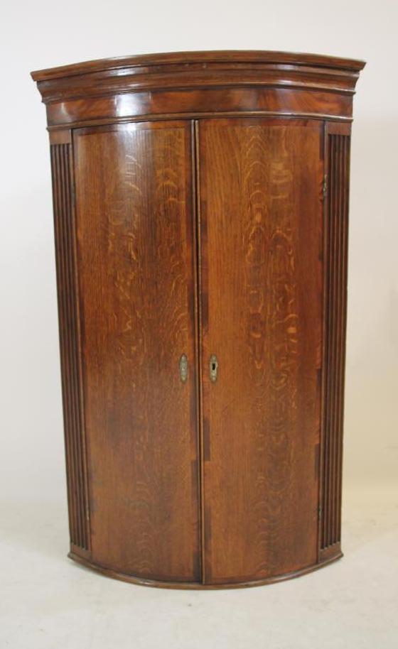 A GEORGIAN OAK CORNER CUPBOARD Image