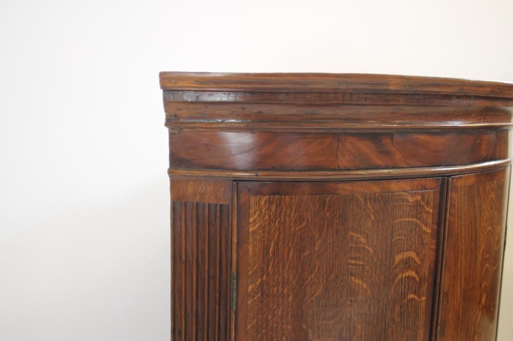 A GEORGIAN OAK CORNER CUPBOARD Image