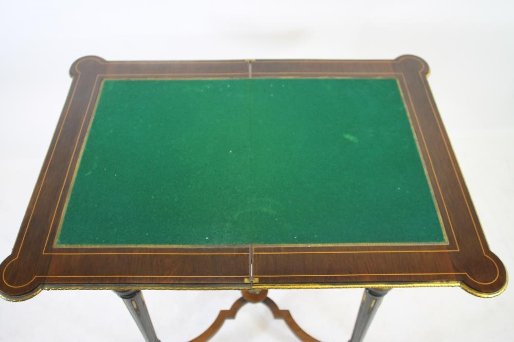 A VICTORIAN KINGWOOD AND MARQUETRY FOLDING CARD TABLE in the French revival style richly inlaid with Image