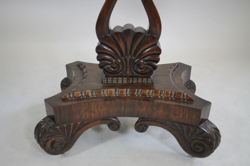 A REGENCY ROSEWOOD FOLDING TEA TABLE of rounded oblong form with swivel top Image