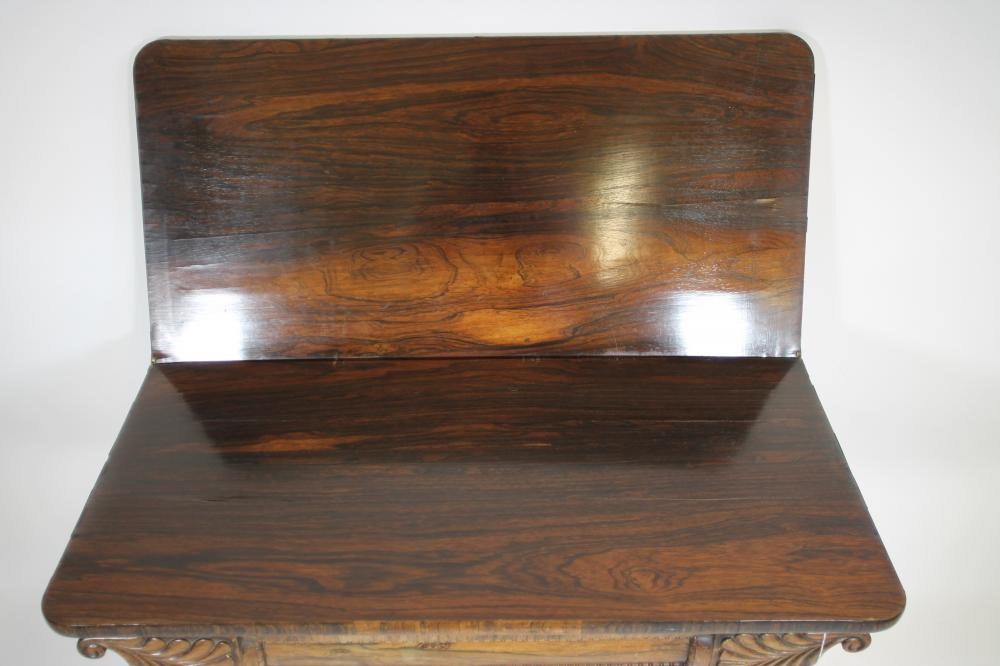 A REGENCY ROSEWOOD FOLDING TEA TABLE of rounded oblong form with swivel top Image