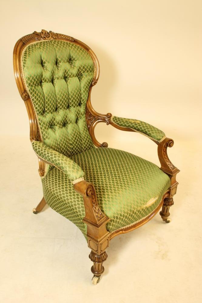 A VICTORIAN CARVED WALNUT SALON CHAIR of spoon back form button upholstered in green silk damask Image