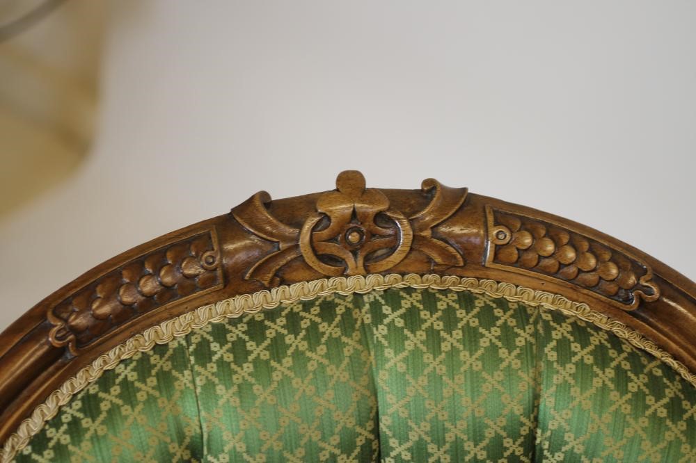 A VICTORIAN CARVED WALNUT SALON CHAIR of spoon back form button upholstered in green silk damask Image