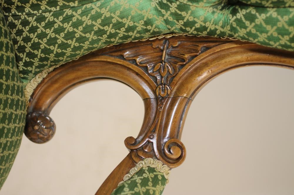 A VICTORIAN CARVED WALNUT SALON CHAIR of spoon back form button upholstered in green silk damask Image