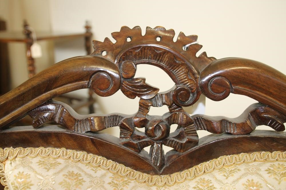 A VICTORIAN MAHOGANY FRAMED ELBOW CHAIR upholstered in ivory and gold weave Image
