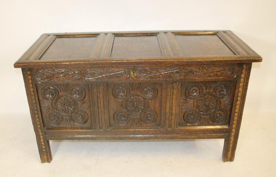 A CARVED OAK PANELLED COFFER Image