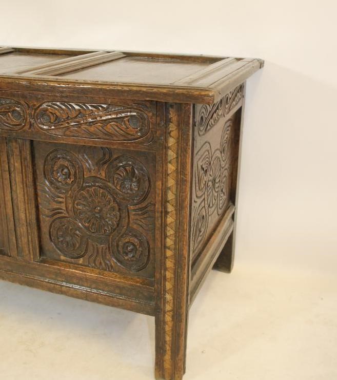 A CARVED OAK PANELLED COFFER Image