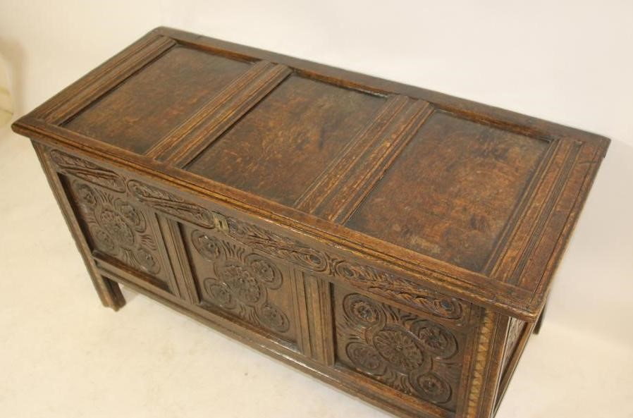 A CARVED OAK PANELLED COFFER Image