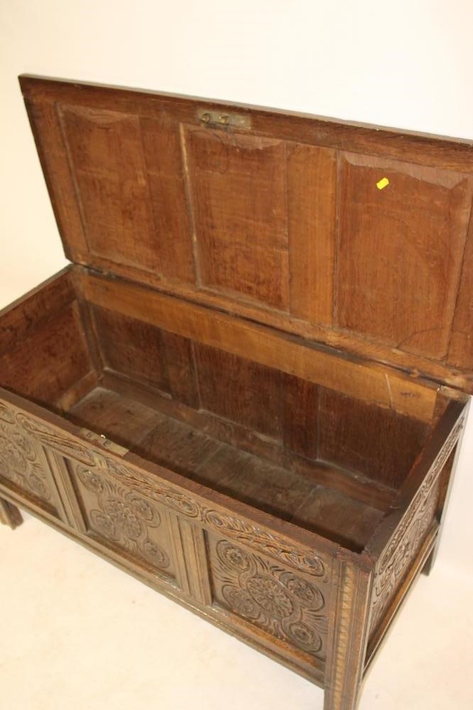 A CARVED OAK PANELLED COFFER Image