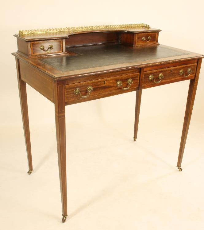 AN EDWARDIAN MAHOGANY WRITING TABLE of oblong form crossbanded with stringing Image