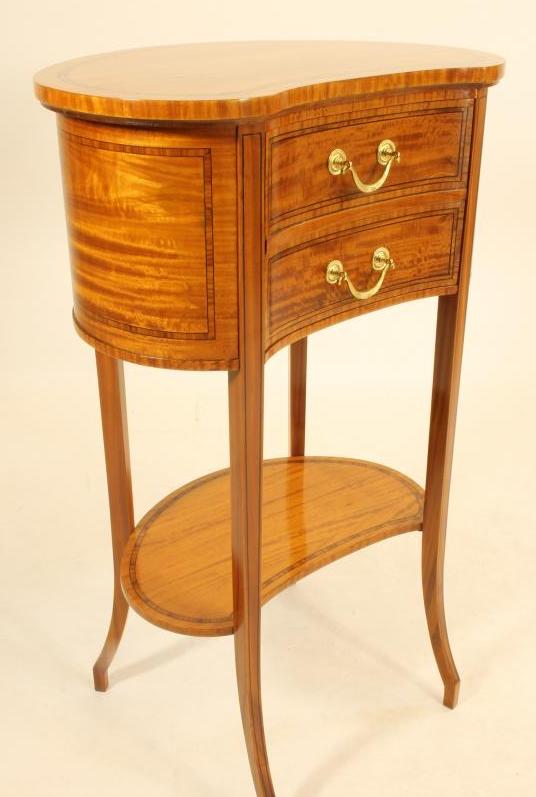 AN EDWARDIAN SATINWOOD BEDSIDE CABINET of kidney form crossbanded with ebony stringing Image