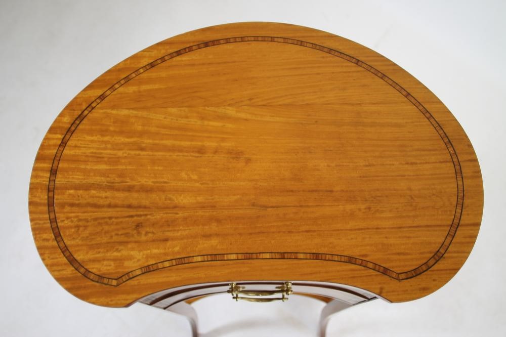 AN EDWARDIAN SATINWOOD BEDSIDE CABINET of kidney form crossbanded with ebony stringing Image