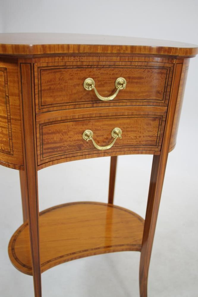 AN EDWARDIAN SATINWOOD BEDSIDE CABINET of kidney form crossbanded with ebony stringing Image