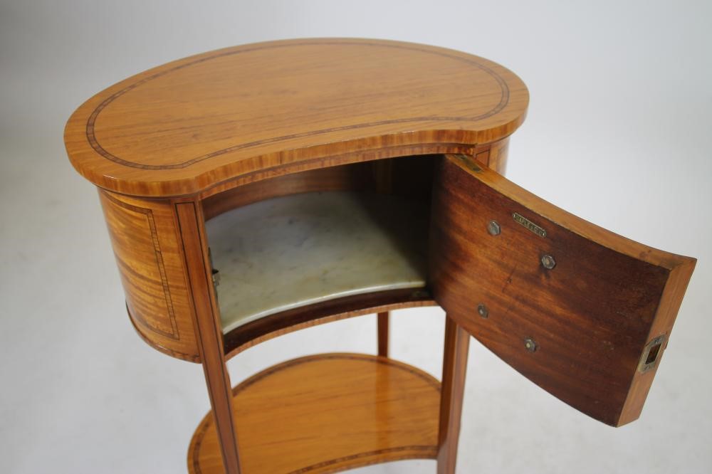 AN EDWARDIAN SATINWOOD BEDSIDE CABINET of kidney form crossbanded with ebony stringing Image