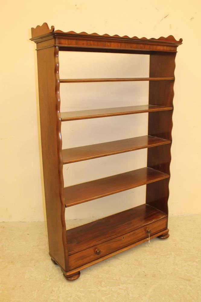 A MAHOGANY OPEN BOOKCASE of rounded oblong form Image