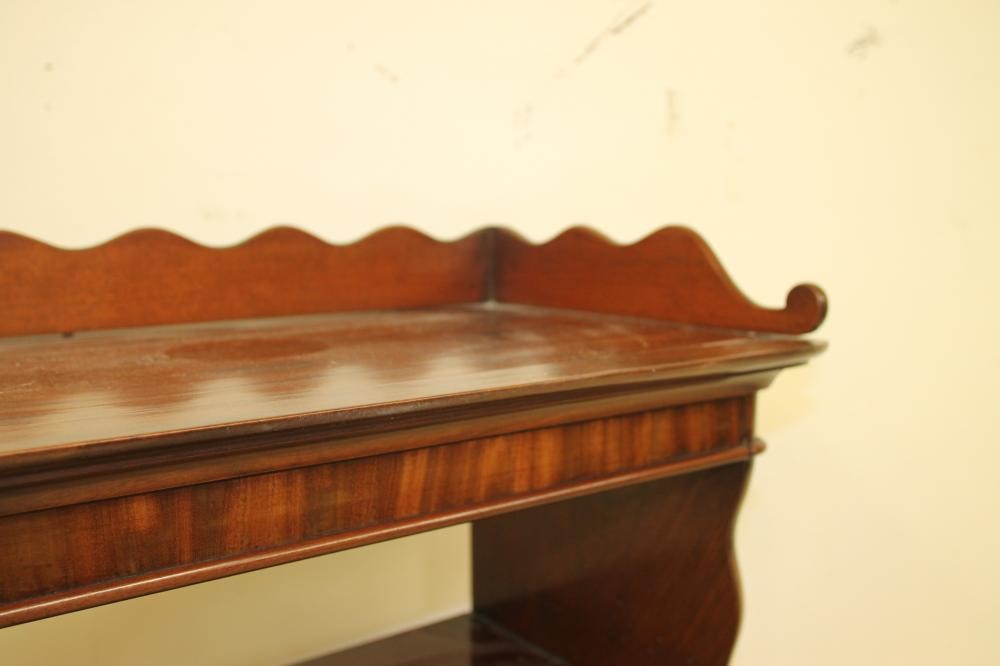 A MAHOGANY OPEN BOOKCASE of rounded oblong form Image