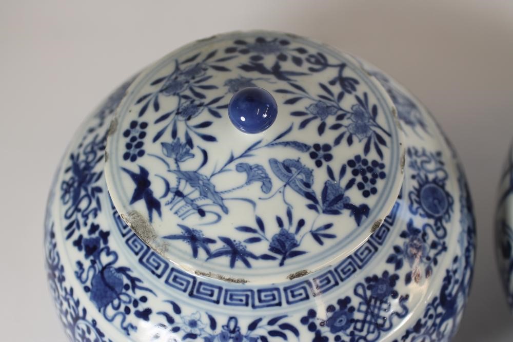 A PAIR OF CHINESE PORCELAIN JARS AND COVERS of squat cylindrical form with sloping shoulders Image