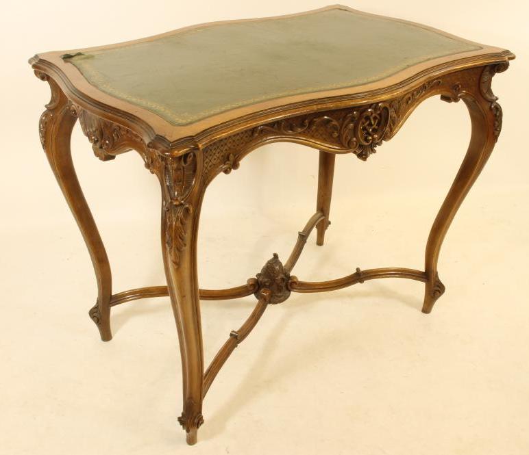 A CARVED WALNUT ROCOCO REVIVAL WRITING TABLE Image