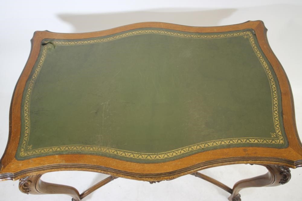 A CARVED WALNUT ROCOCO REVIVAL WRITING TABLE Image