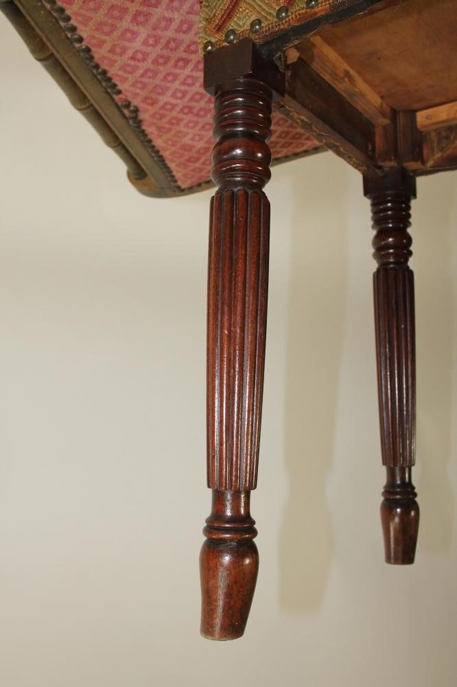 A REGENCY PAINTED X FRAMED STOOL of dished oblong form with faux bamboo side handles Image