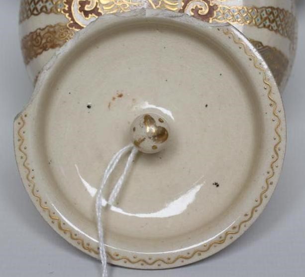 A SATSUMA EARTHENWARE JAR AND COVERS Image