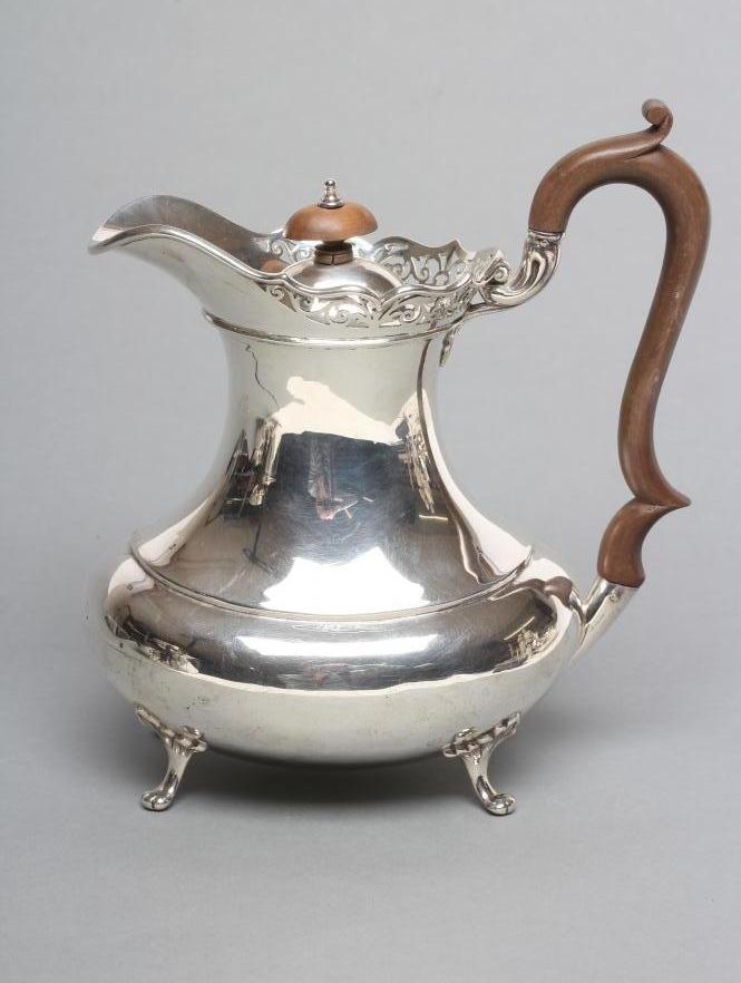 A SILVER COFFEE POT Image