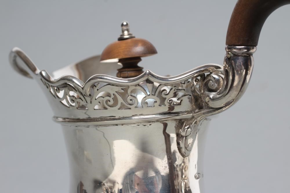 A SILVER COFFEE POT Image