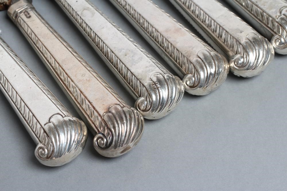 A COMPOSITE SET OF TWELVE GEORGE III SILVER PISTOL GRIP HANDLED TABLE KNIVES Image