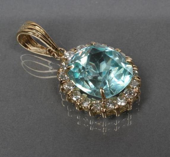 A BLUE ZIRCON AND DIAMOND OVAL PENDANT Image