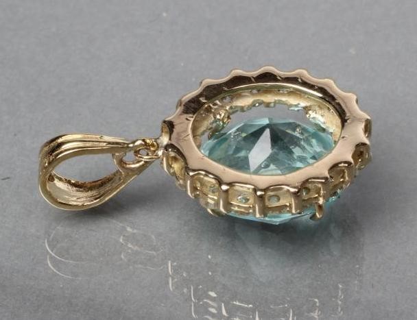 A BLUE ZIRCON AND DIAMOND OVAL PENDANT Image
