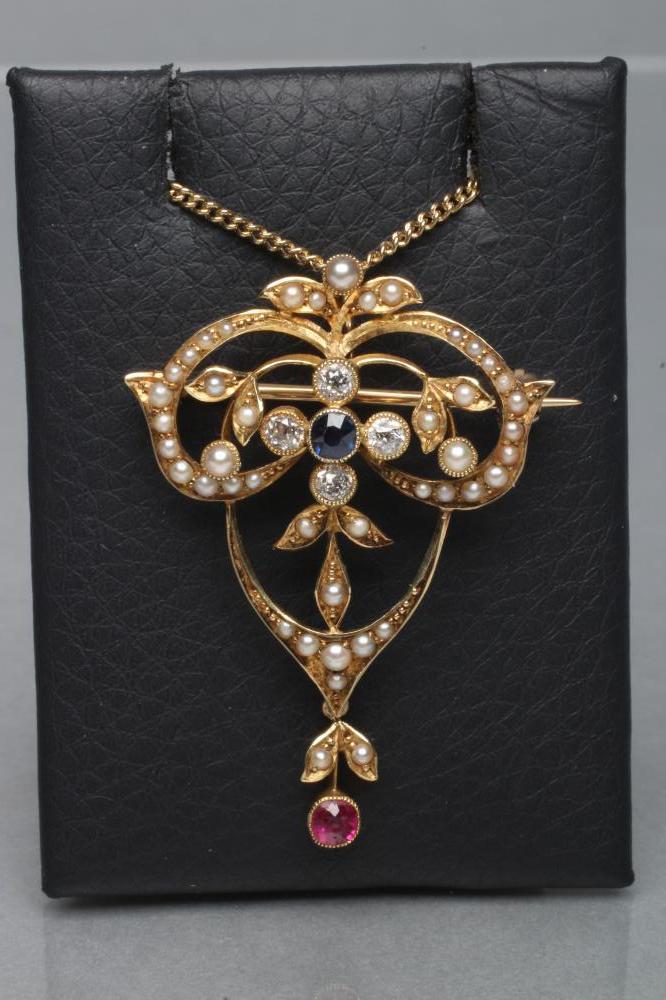 AN EDWARDIAN OPEN PENDANT/BROOCH set with seed pearls and centred by a circular sapphire and four Image