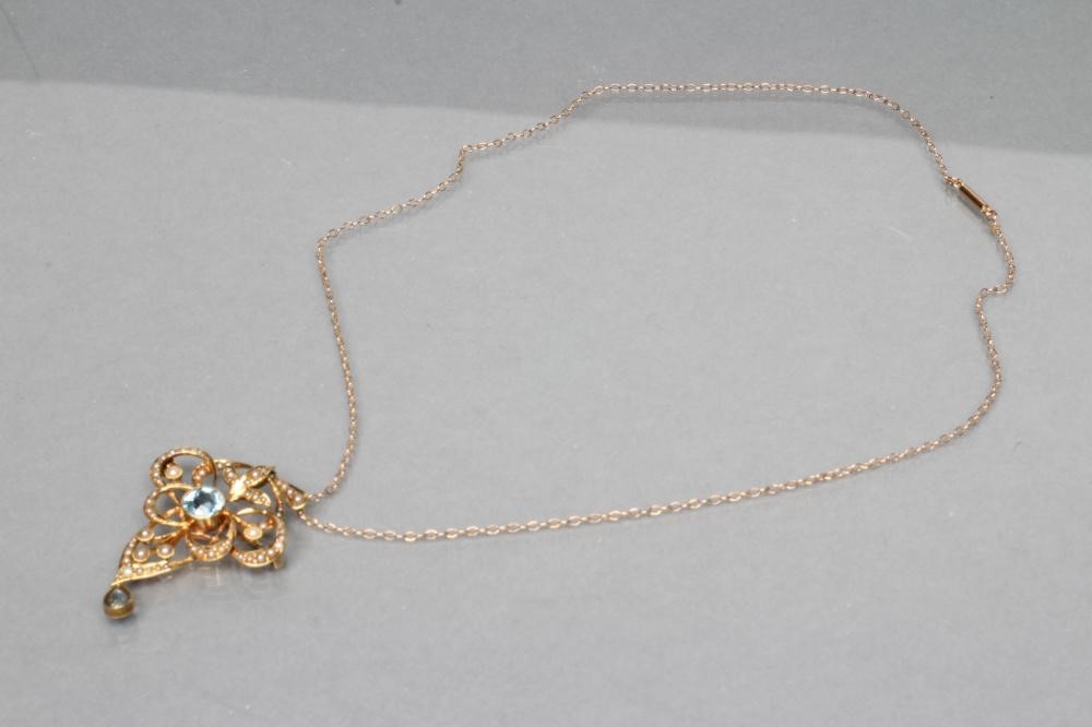 AN EDWARDIAN OPEN PENDANT/BROOCH centred by a collet set facet cut aquamarine and hung with a Image