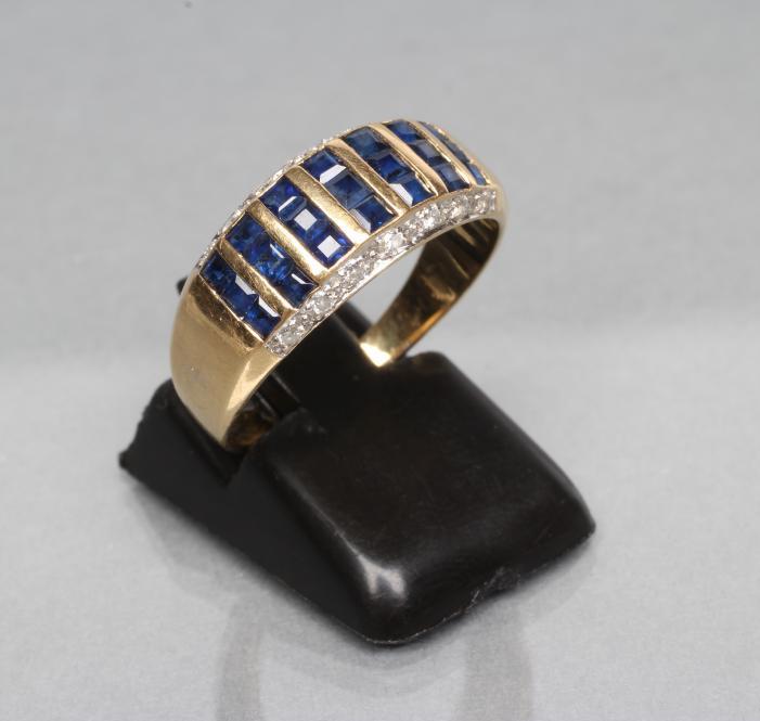 A SAPPHIRE AND DIAMOND HALF HOOP RING Image