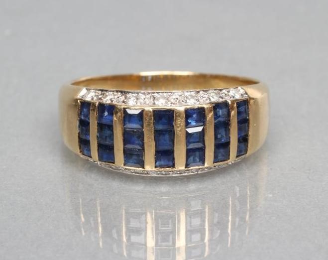 A SAPPHIRE AND DIAMOND HALF HOOP RING Image